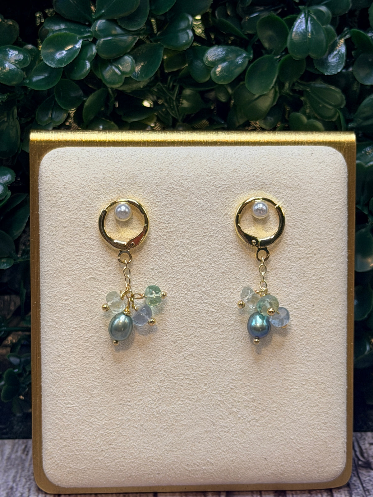 Peacock green freshwater pearls with a cluster of multicolored fluorite gemstones