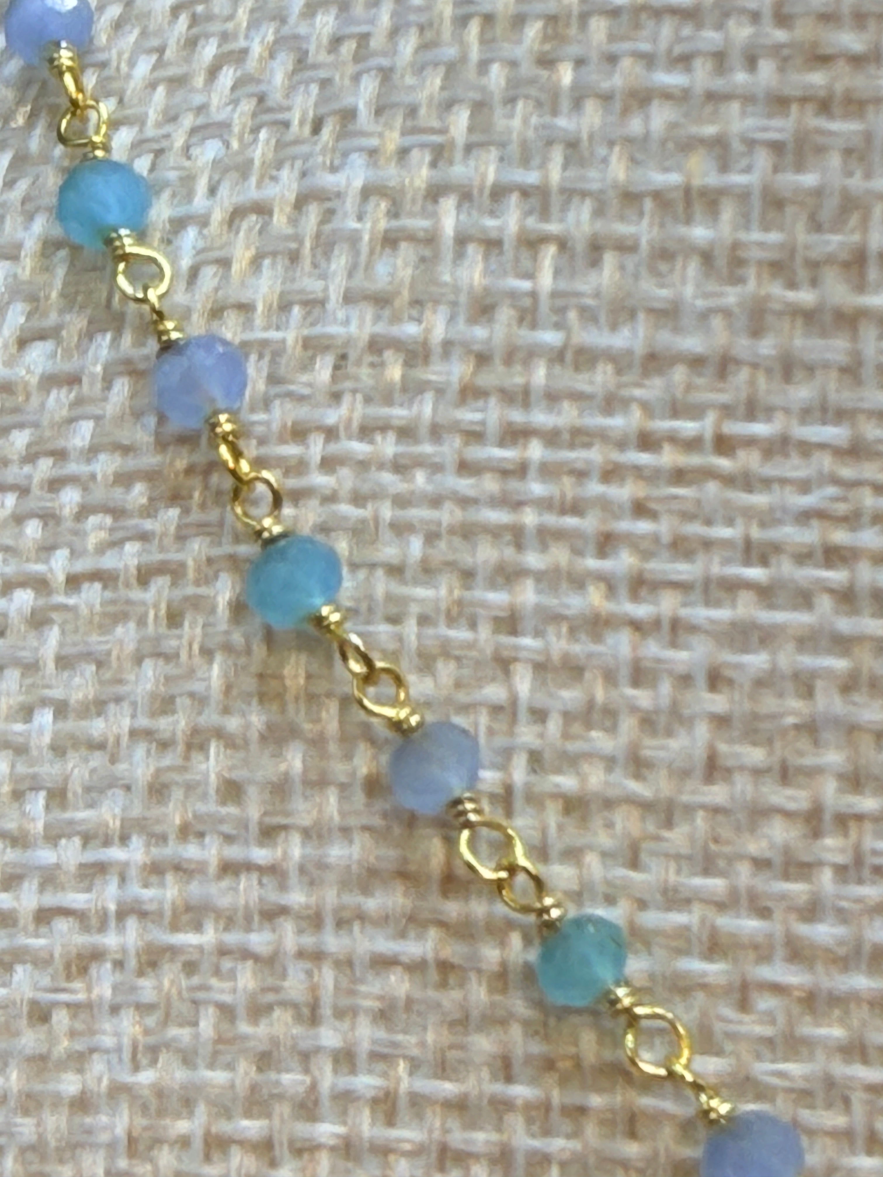 Aqua and blue chalcedony faceted rondelles on a vermeil hand
