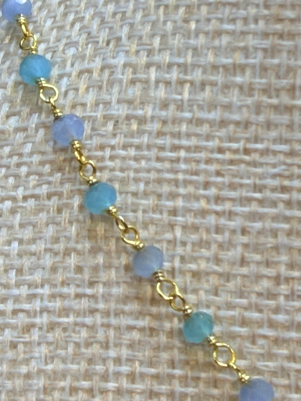 Aqua and blue chalcedony faceted rondelles on a vermeil hand wrapped chain.